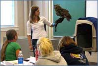 Informal science instructor holding an owl.